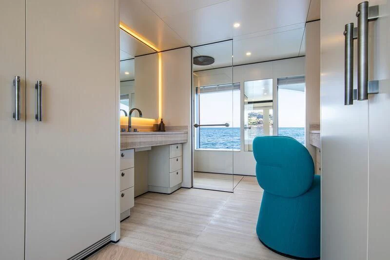 a kitchen with a blue chair aboard LL Yacht for Sale