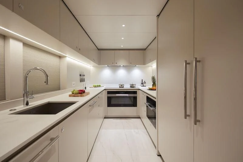 a kitchen with white cabinets aboard LL Yacht for Sale
