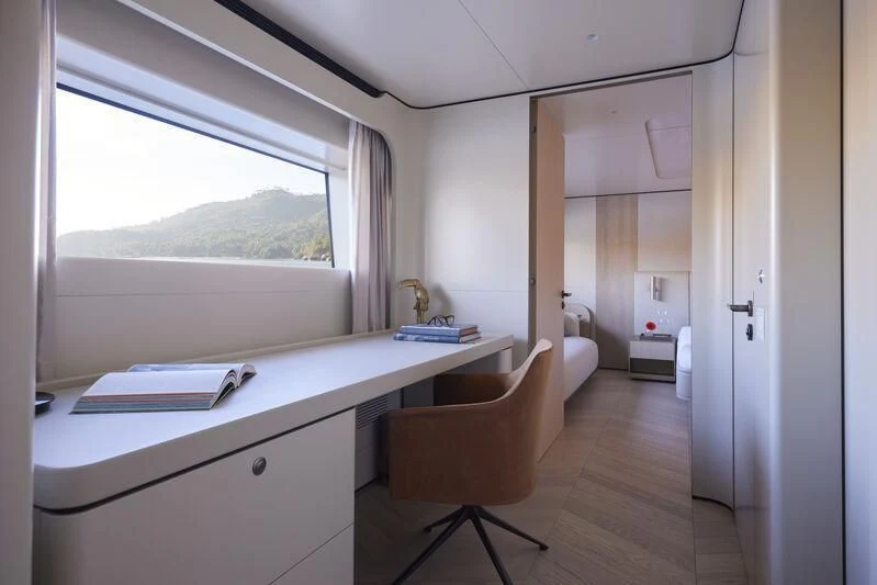 a room with a desk and a chair aboard LL Yacht for Sale