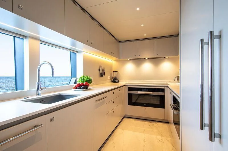 a kitchen with white cabinets aboard LL Yacht for Sale