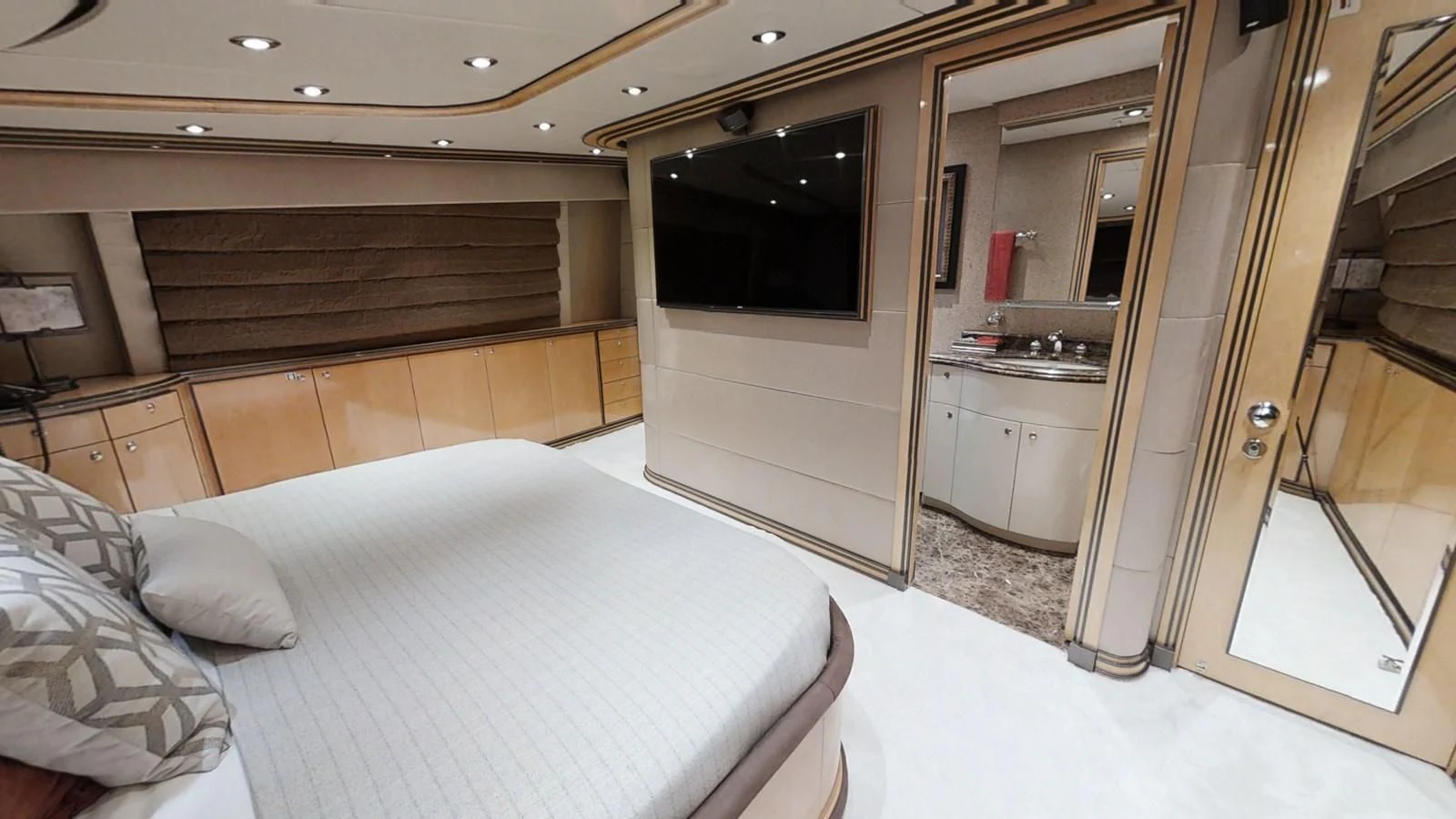 a bedroom with a bed and a tv aboard ENTOURAGE Yacht for Sale
