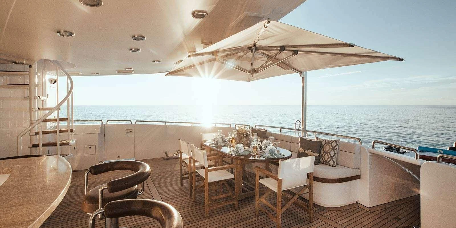 a large white tent with chairs and tables on a deck aboard ENTOURAGE Yacht for Sale