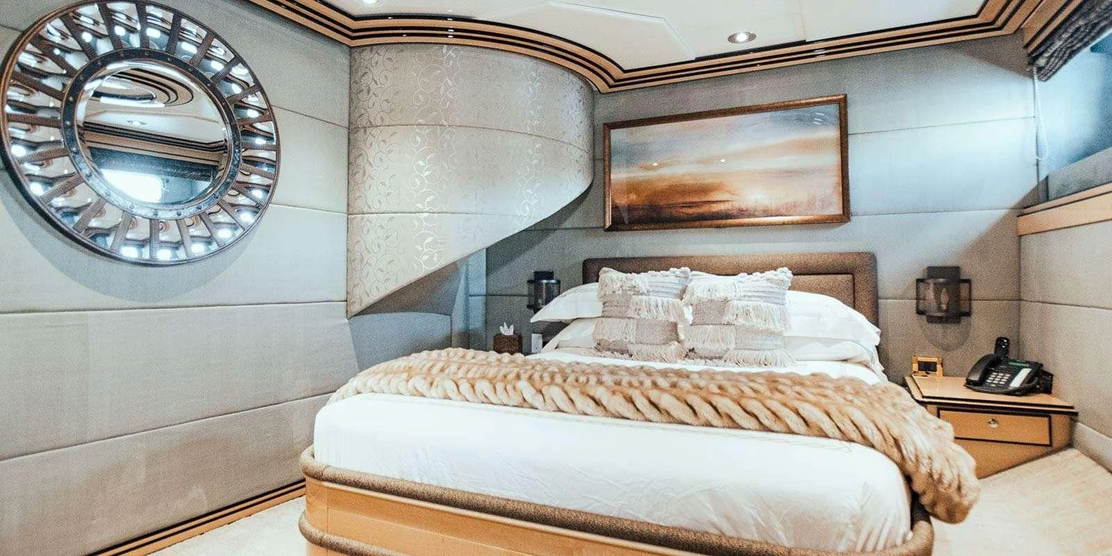 a bed with a round mirror above it aboard ENTOURAGE Yacht for Sale
