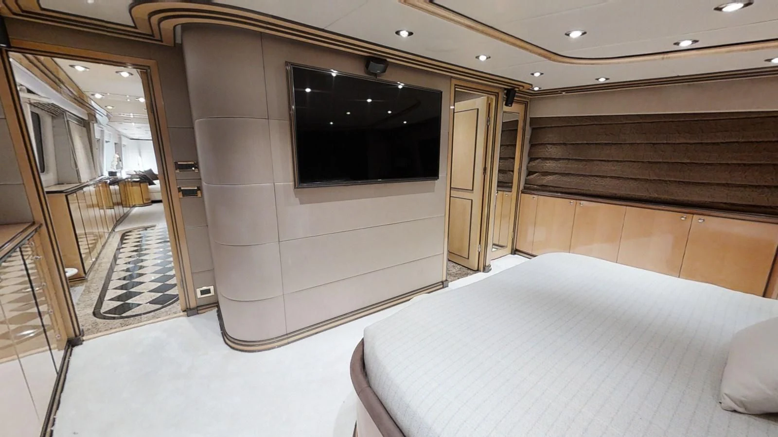 a room with a bed and a television aboard ENTOURAGE Yacht for Sale