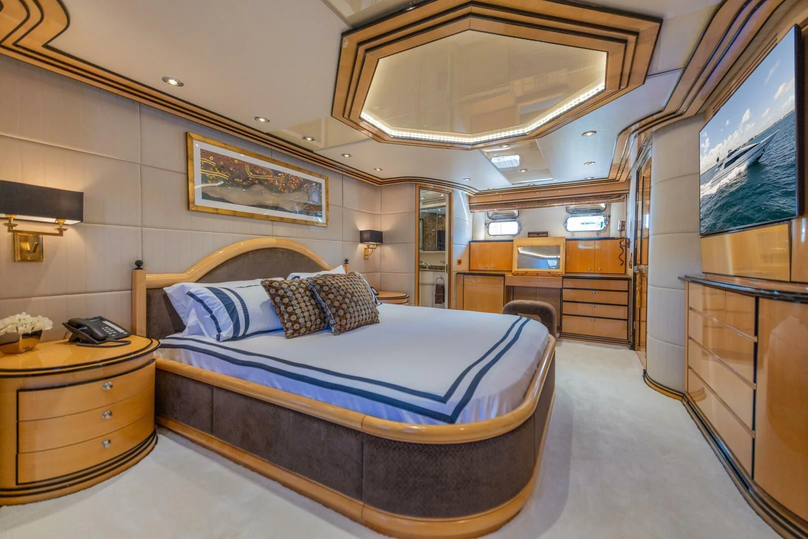 a bedroom with a bed and a desk aboard ENTOURAGE Yacht for Sale