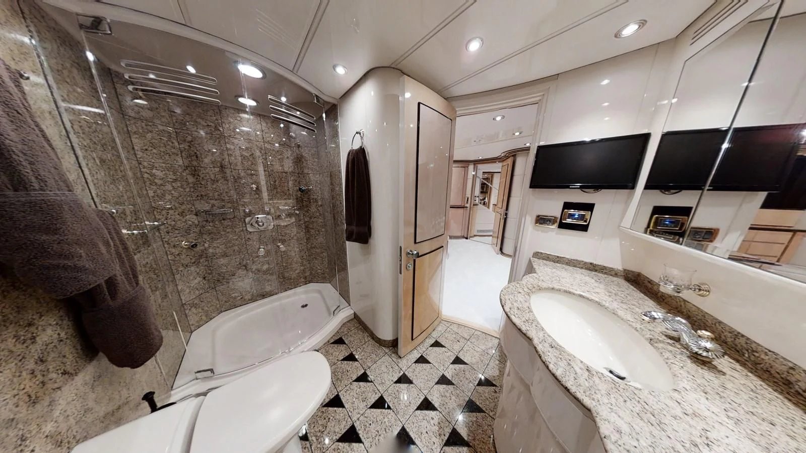 a bathroom with a large rock wall aboard ENTOURAGE Yacht for Sale