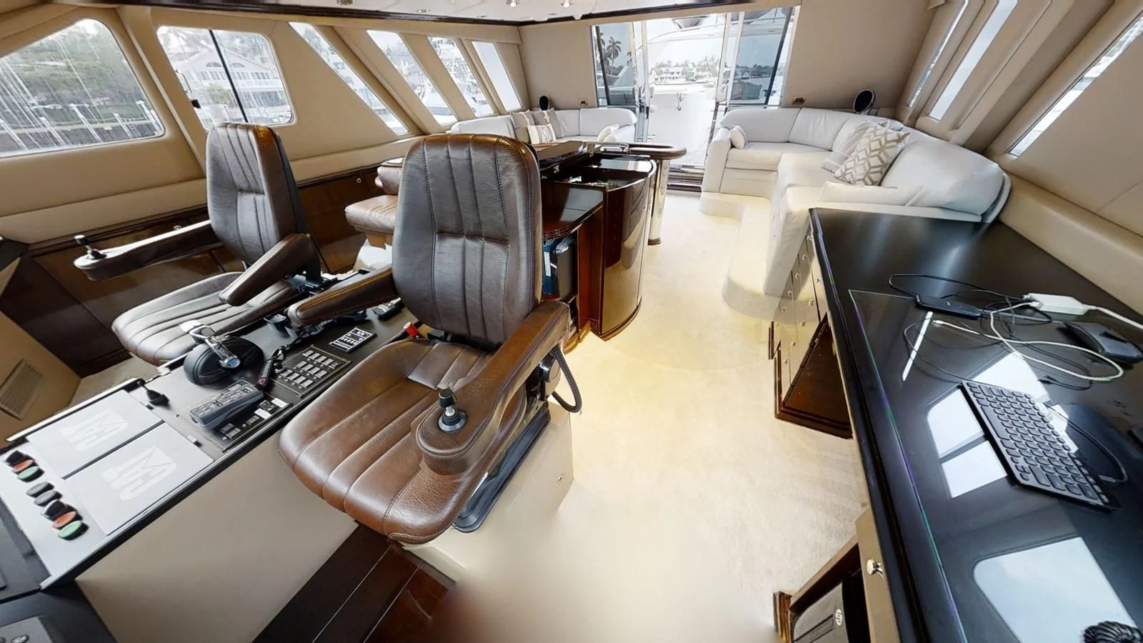 a room with a couch and a desk with a computer aboard ENTOURAGE Yacht for Sale