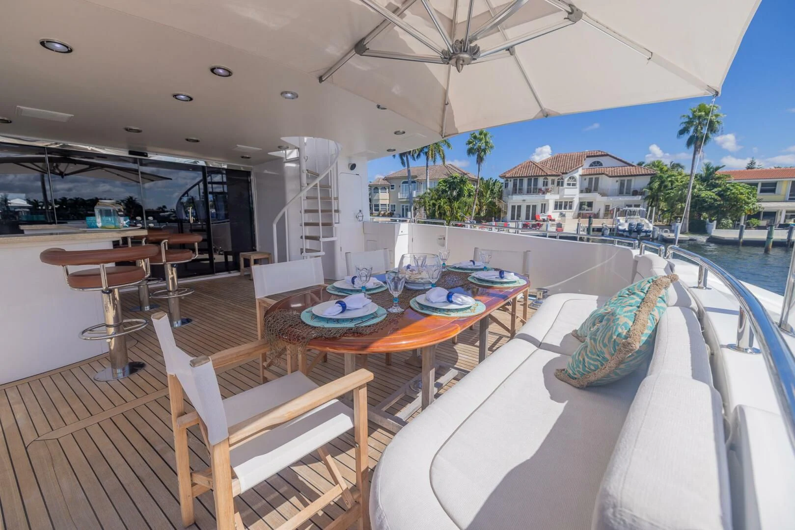 a large outdoor patio with tables and chairs aboard ENTOURAGE Yacht for Sale