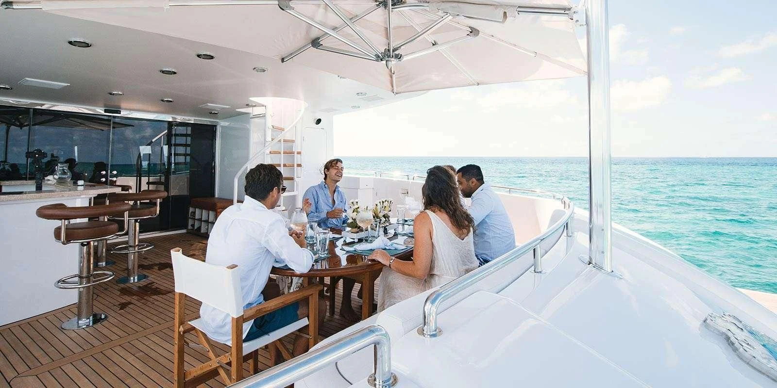 a group of people sitting on a boat aboard ENTOURAGE Yacht for Sale