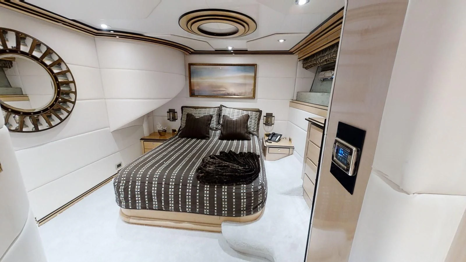 a bedroom with a bed and a mirror aboard ENTOURAGE Yacht for Sale