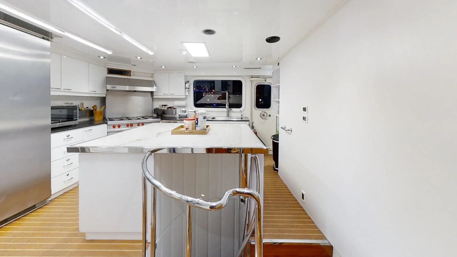 a kitchen with a fridge and a microwave aboard ENTOURAGE Yacht for Sale