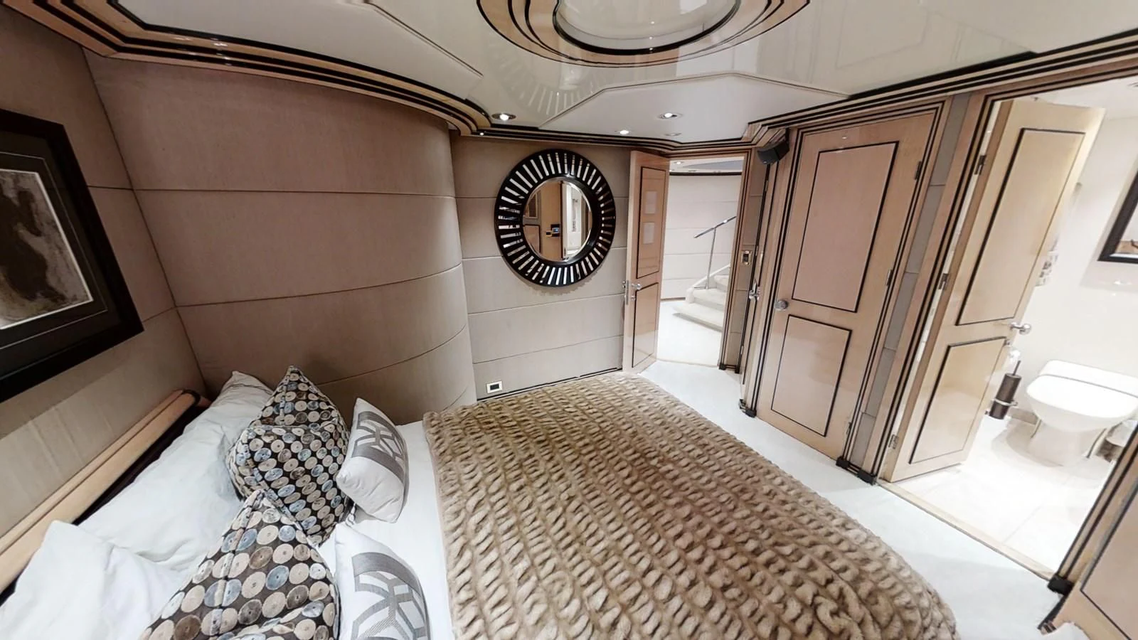 a bedroom with a bed and a mirror aboard ENTOURAGE Yacht for Sale