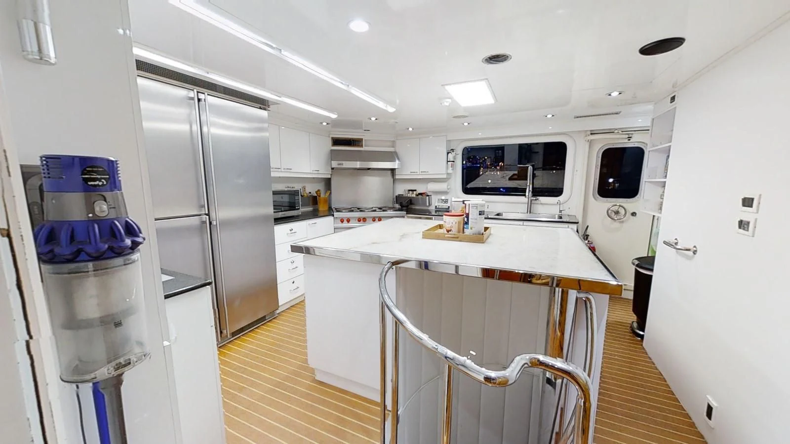 a kitchen with a fridge and a microwave aboard ENTOURAGE Yacht for Sale