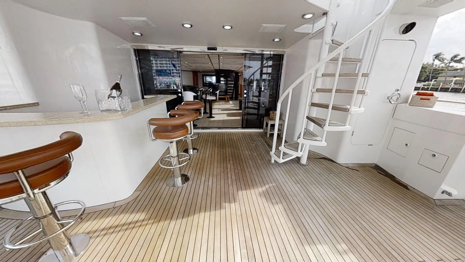 a room with a staircase and chairs aboard ENTOURAGE Yacht for Sale