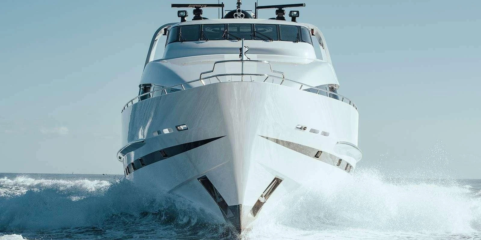 a white yacht on the water aboard ENTOURAGE Yacht for Sale