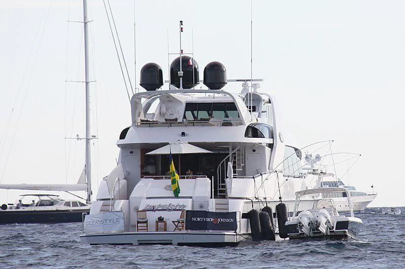 a large white boat on the water aboard ENTOURAGE Yacht for Sale