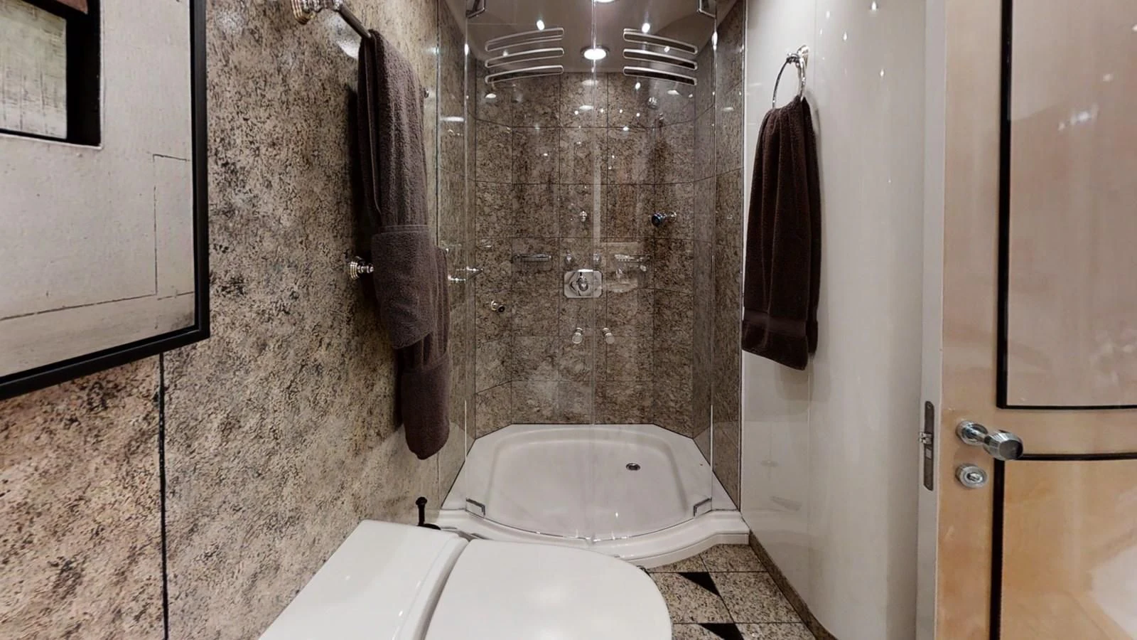 a bathroom with a toilet and a shower aboard ENTOURAGE Yacht for Sale