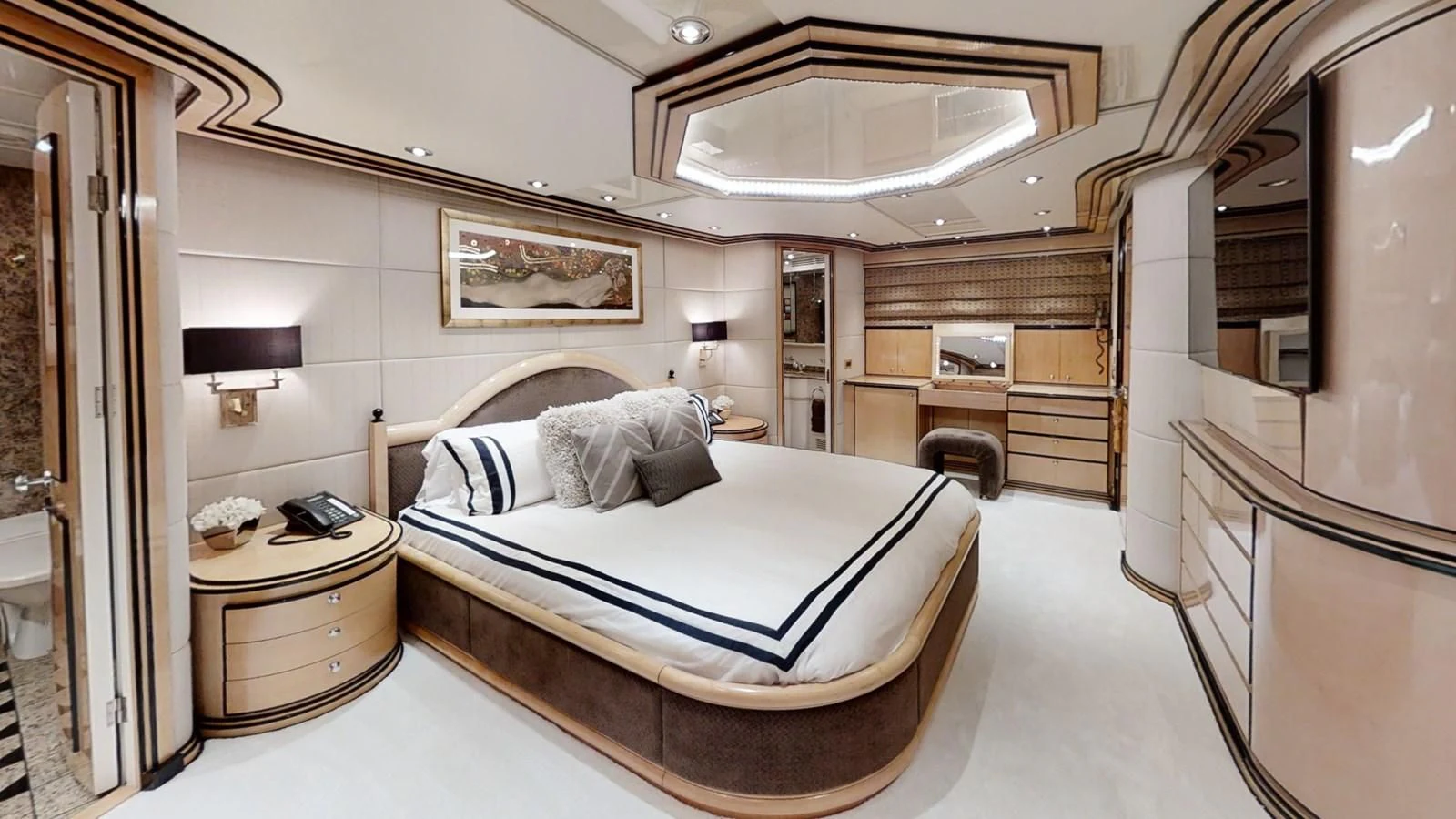 a bedroom with a bed and a desk aboard ENTOURAGE Yacht for Sale