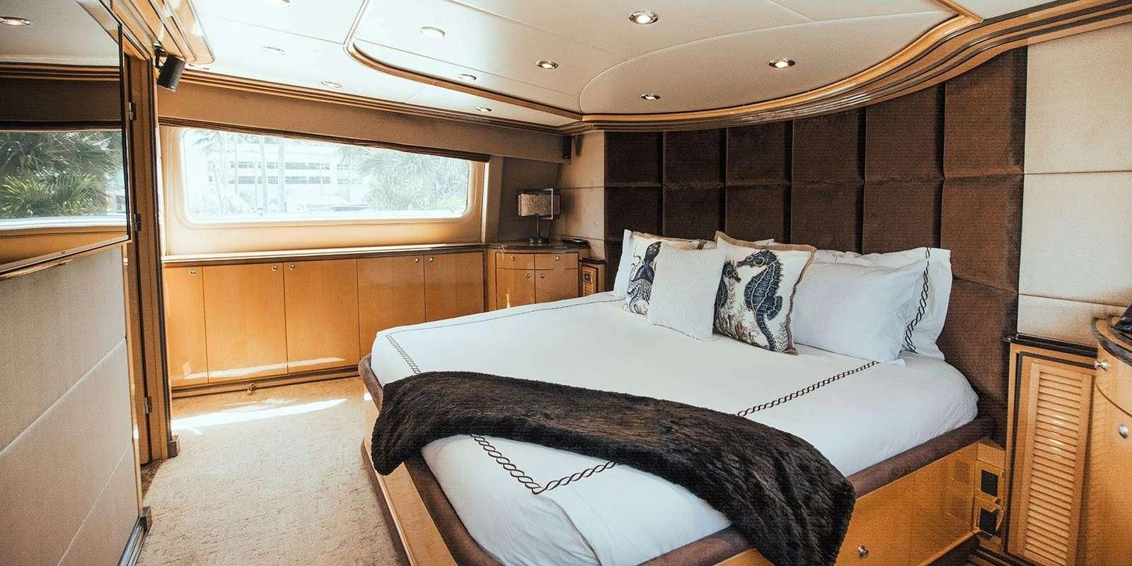 a room with a bed and a window aboard ENTOURAGE Yacht for Sale