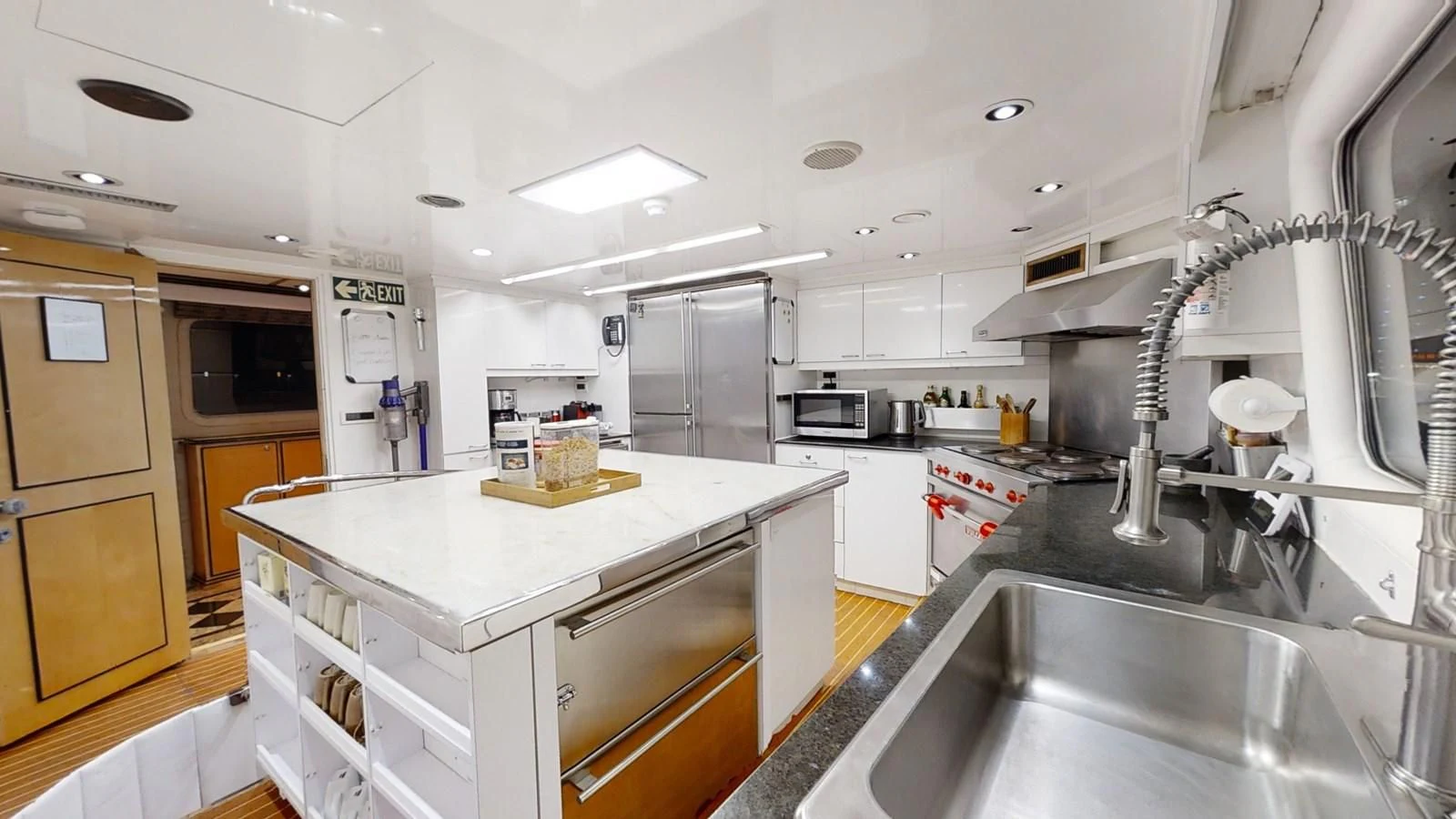 a kitchen with a large island aboard ENTOURAGE Yacht for Sale
