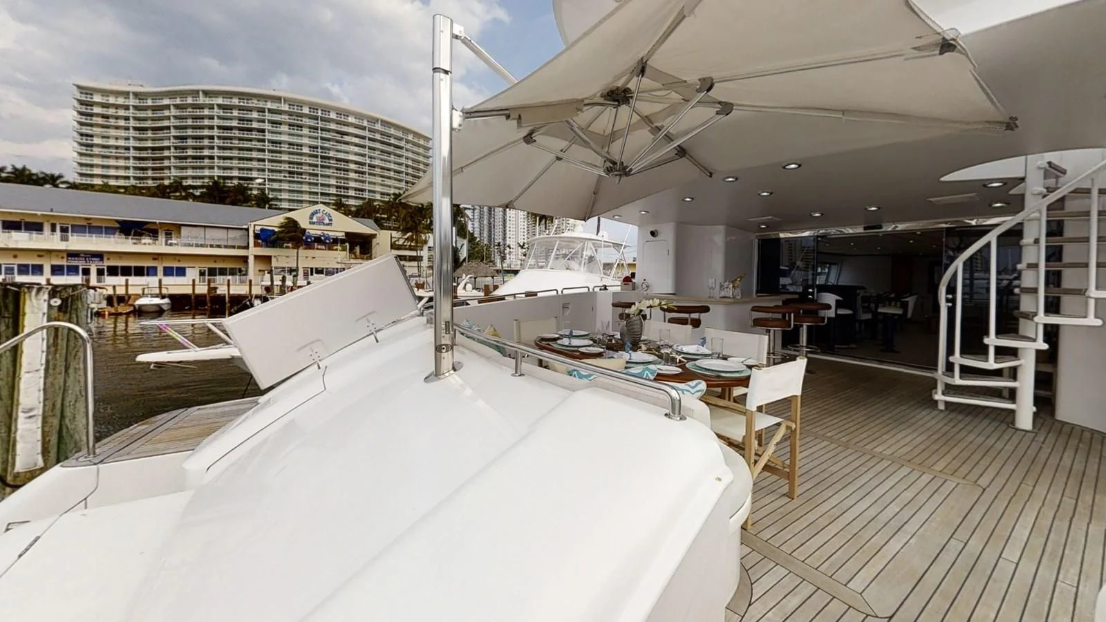 a large room with tables and chairs aboard ENTOURAGE Yacht for Sale