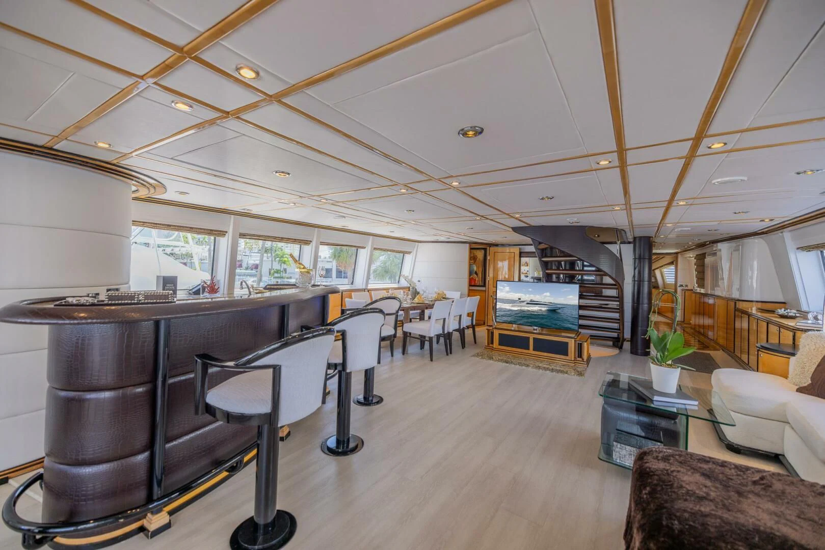 a large room with a piano and chairs aboard ENTOURAGE Yacht for Sale