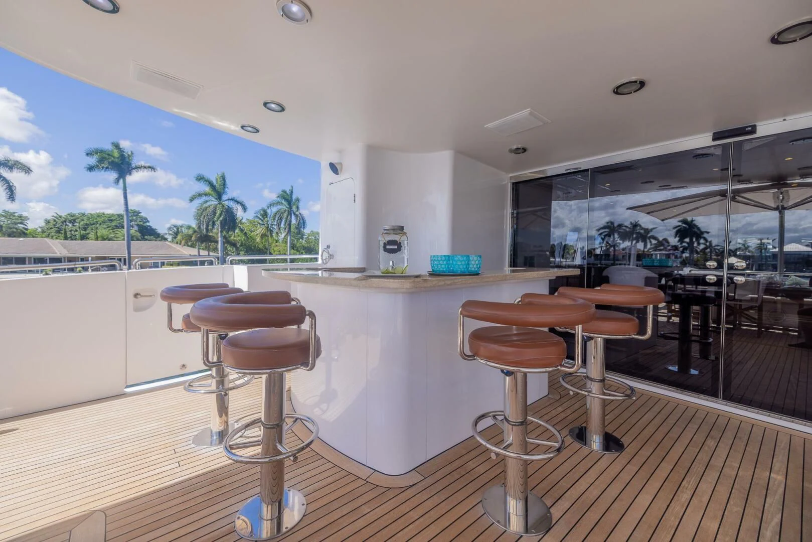 a room with stools and tables aboard ENTOURAGE Yacht for Sale