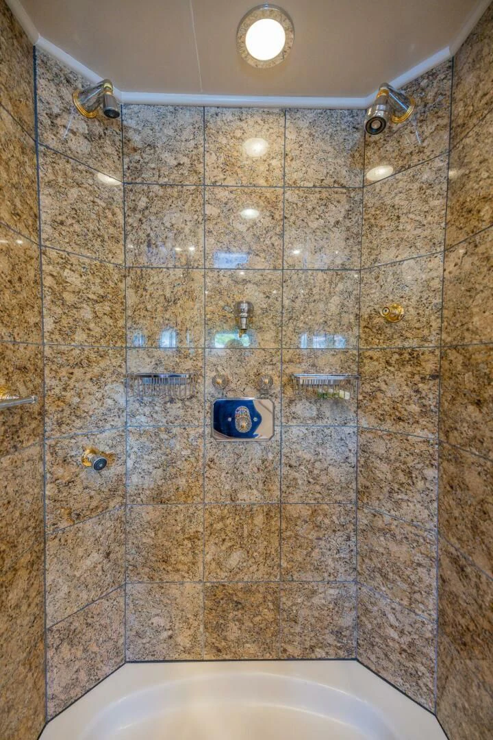 a bathroom with tile walls aboard ENTOURAGE Yacht for Sale