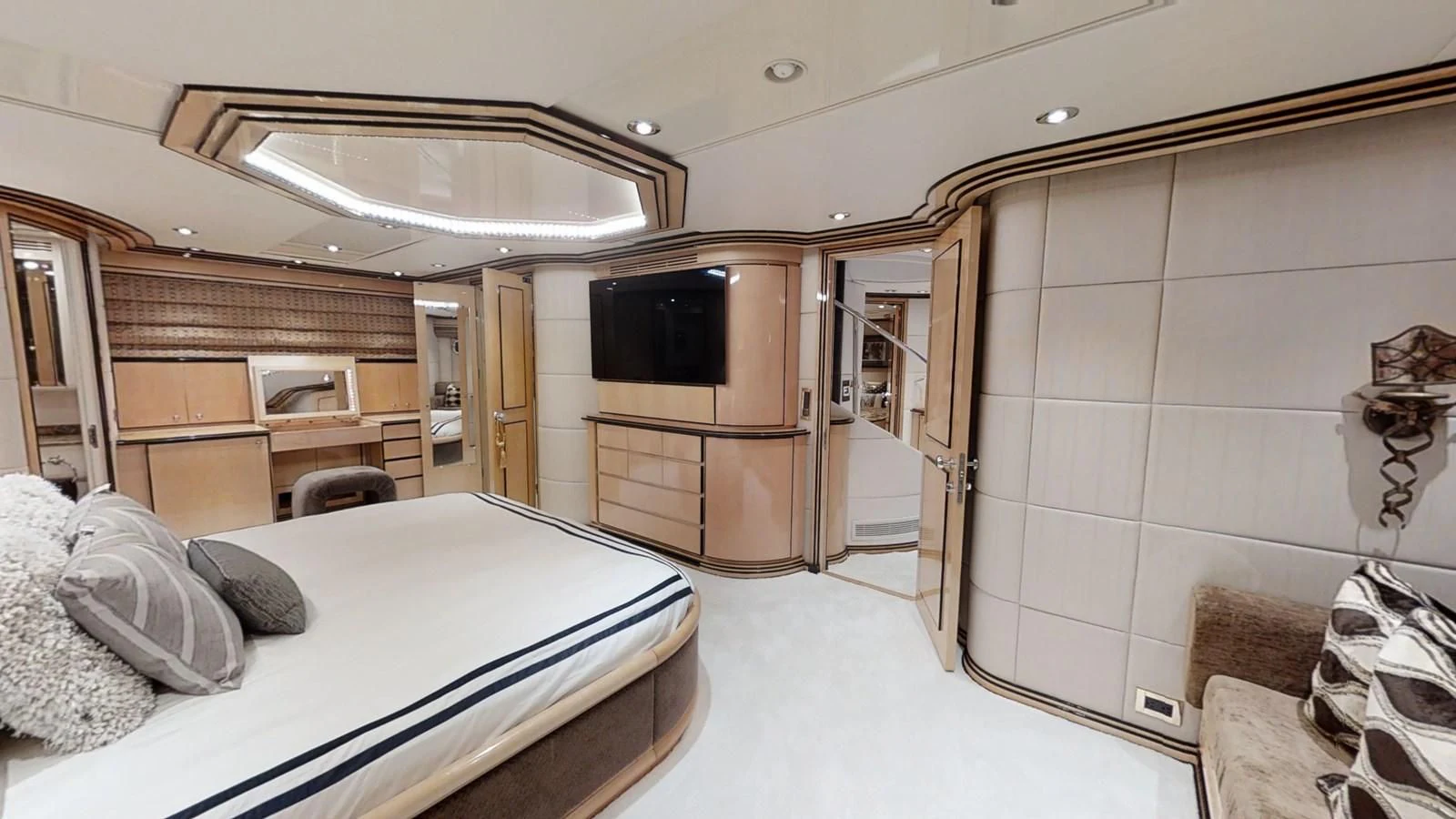 a bedroom with a bed and a television aboard ENTOURAGE Yacht for Sale