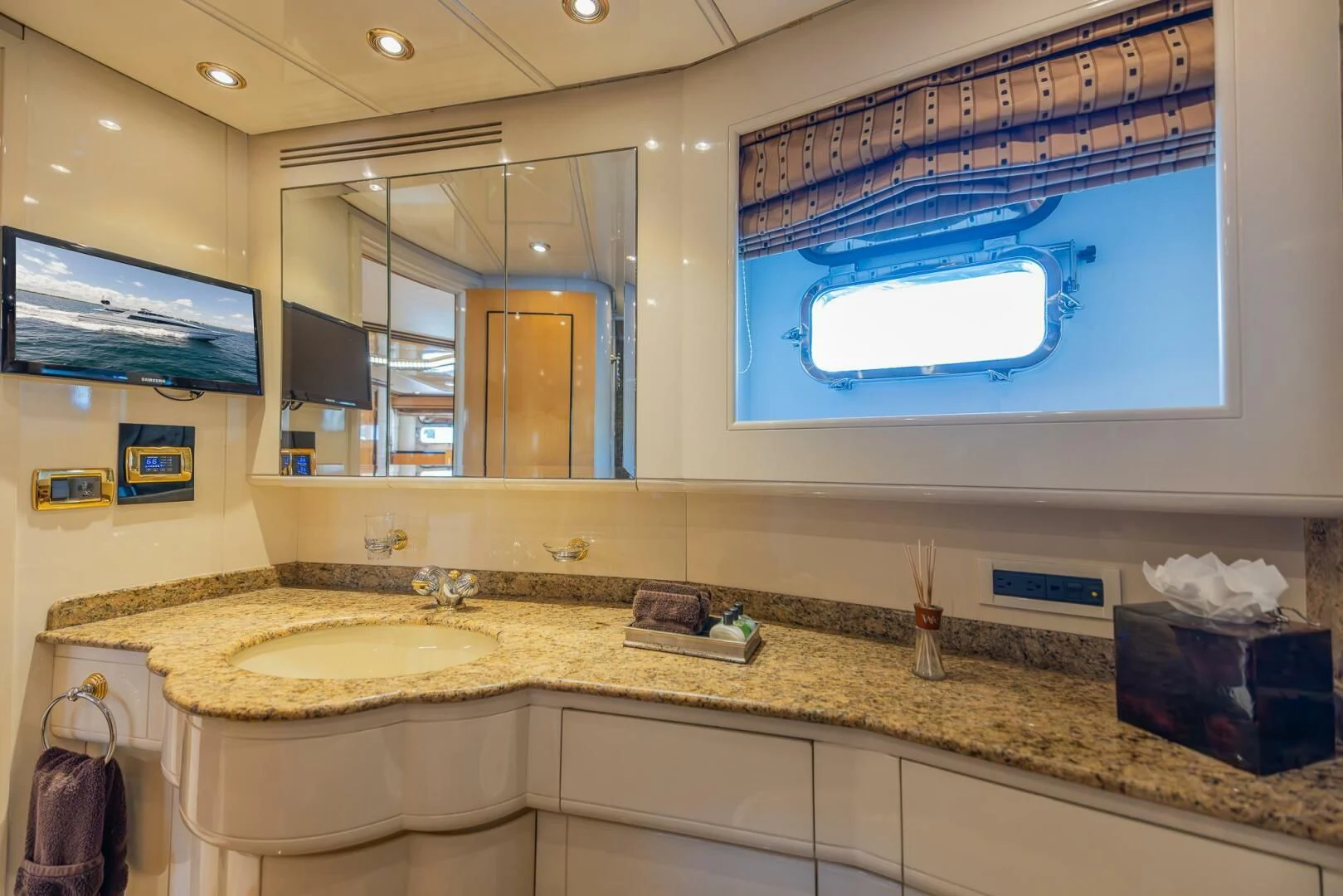 a bathroom with a countertop sink and a large mirror aboard ENTOURAGE Yacht for Sale