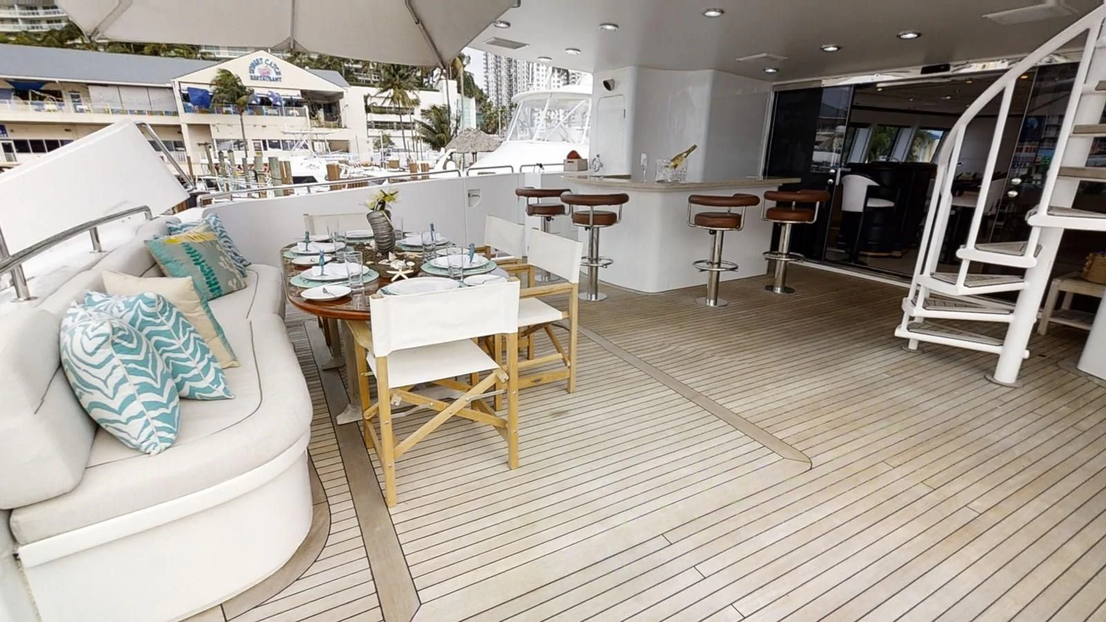 a room with tables and chairs aboard ENTOURAGE Yacht for Sale