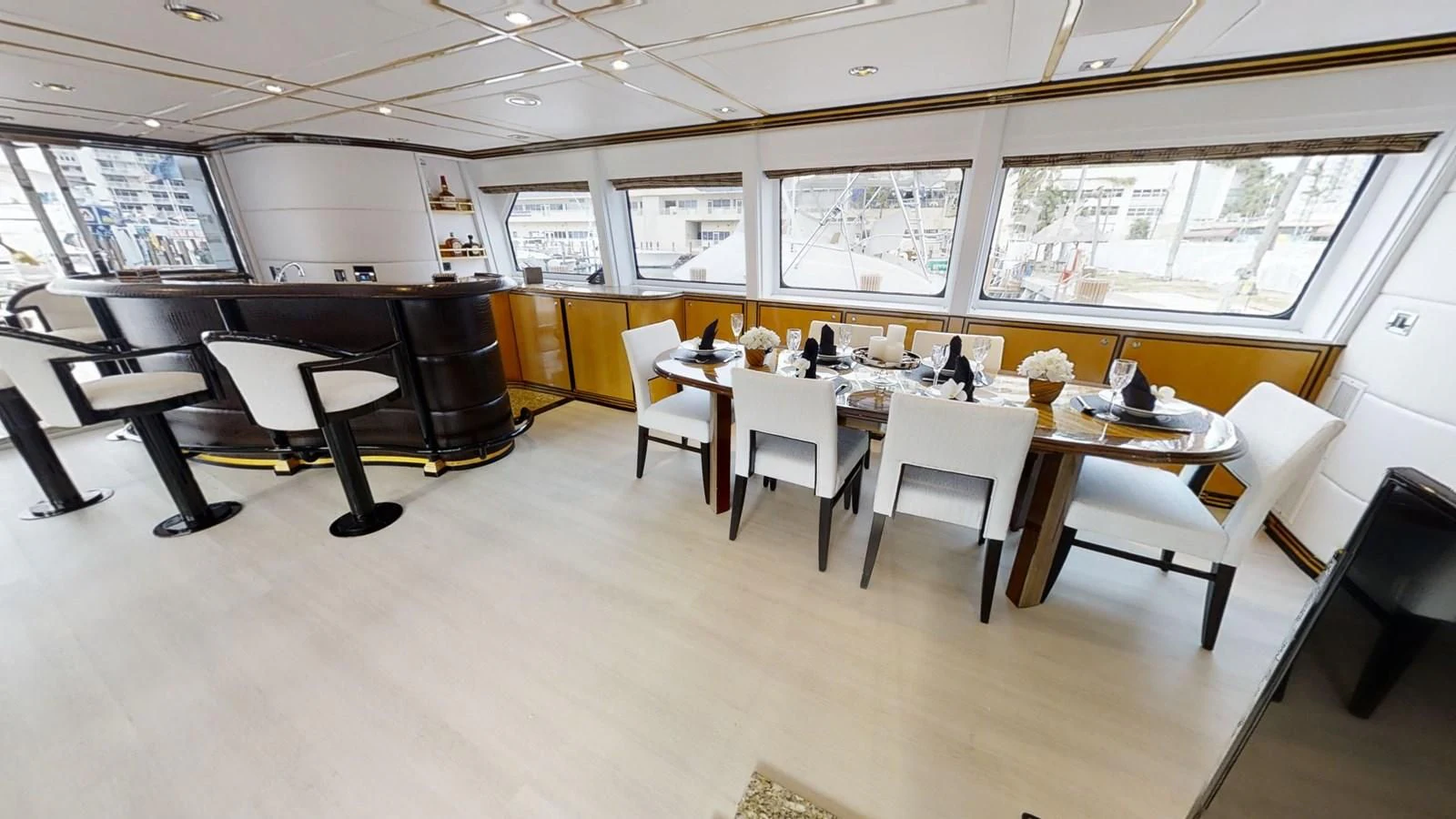 a room with tables and chairs aboard ENTOURAGE Yacht for Sale