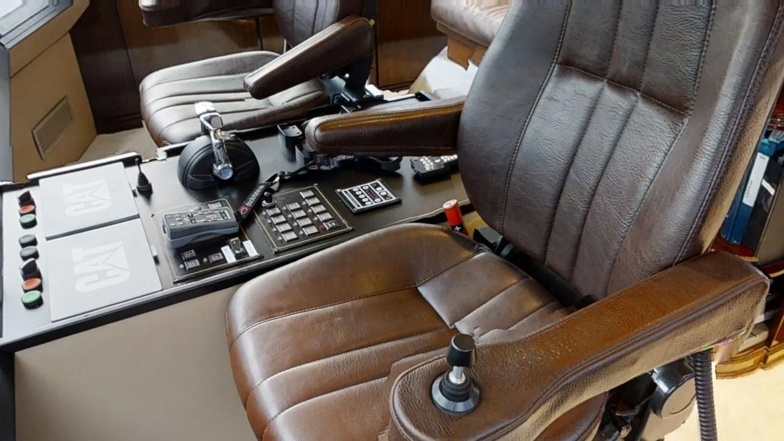 a leather chair with a computer and a desk with a computer and a keyboard on it aboard ENTOURAGE Yacht for Sale
