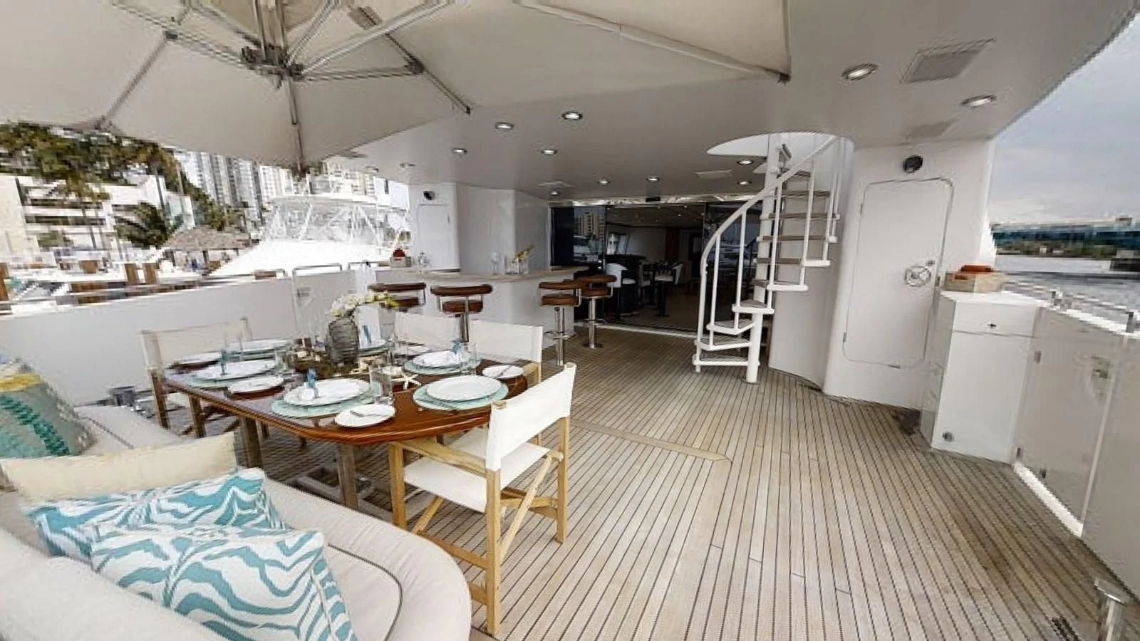 a large white kitchen with a dining table and chairs aboard ENTOURAGE Yacht for Sale