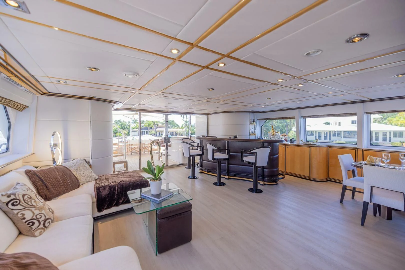 a living room with a piano and a large window aboard ENTOURAGE Yacht for Sale