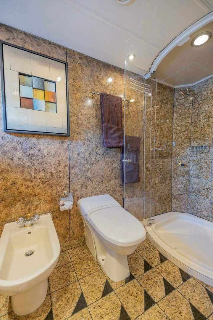 a bathroom with a toilet and a bathtub aboard ENTOURAGE Yacht for Sale