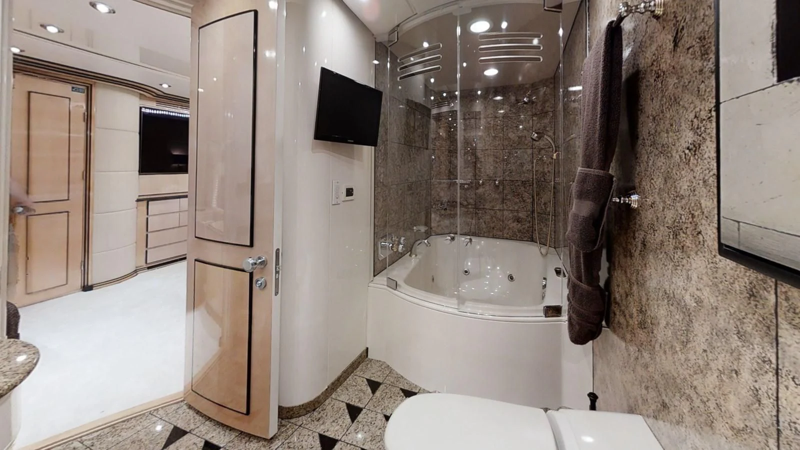 a bathroom with a tub and shower aboard ENTOURAGE Yacht for Sale