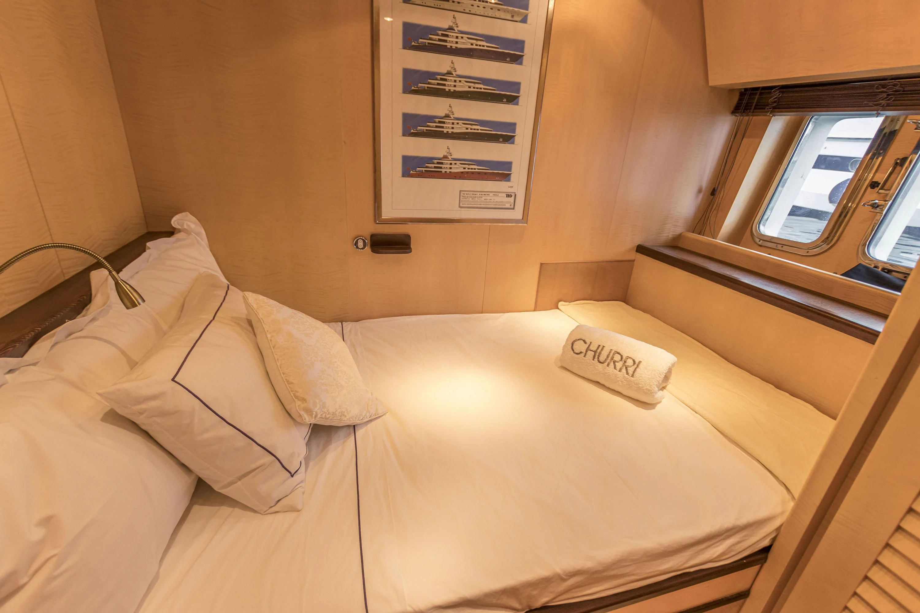 a bed with a phone on it aboard VELOCE Yacht for Sale