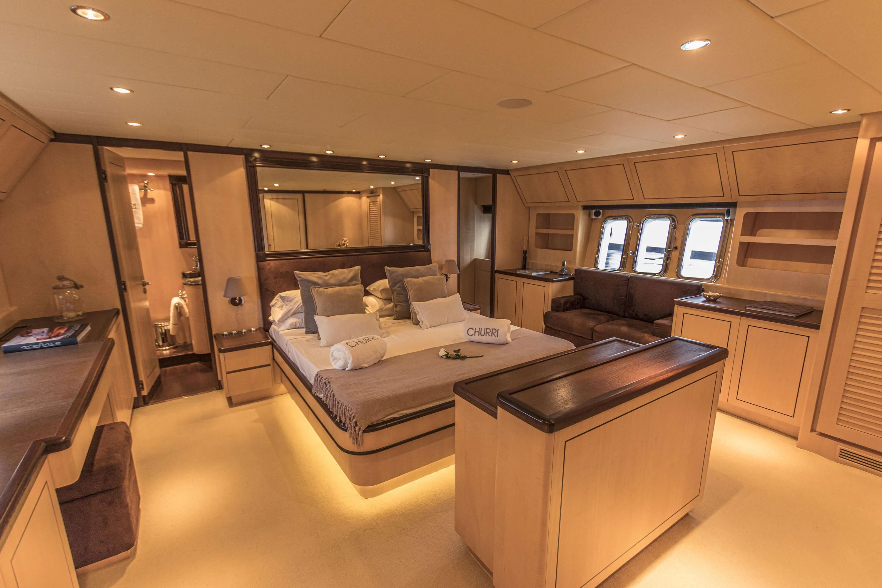 a large room with a bed and desk aboard VELOCE Yacht for Sale