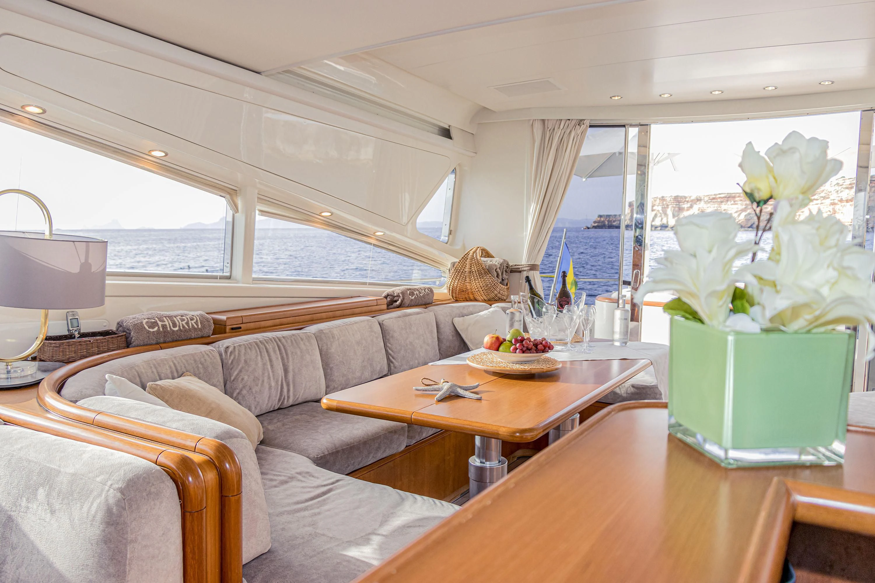 a living room with a couch and a table aboard VELOCE Yacht for Sale