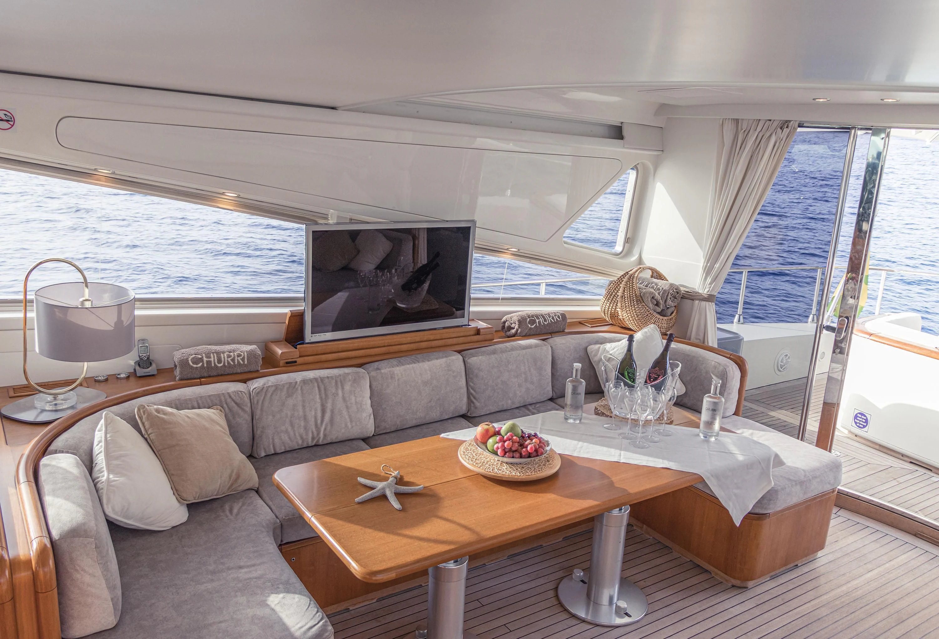 a person sitting on a couch in a living room aboard VELOCE Yacht for Sale