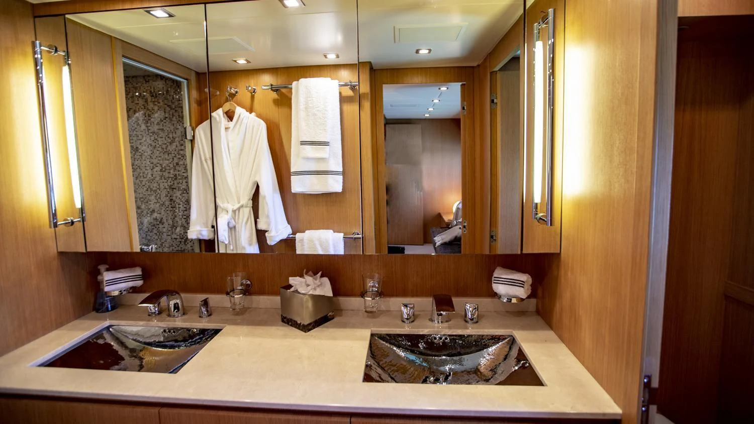 a bathroom with a robe on the wall aboard VELOCE Yacht for Sale