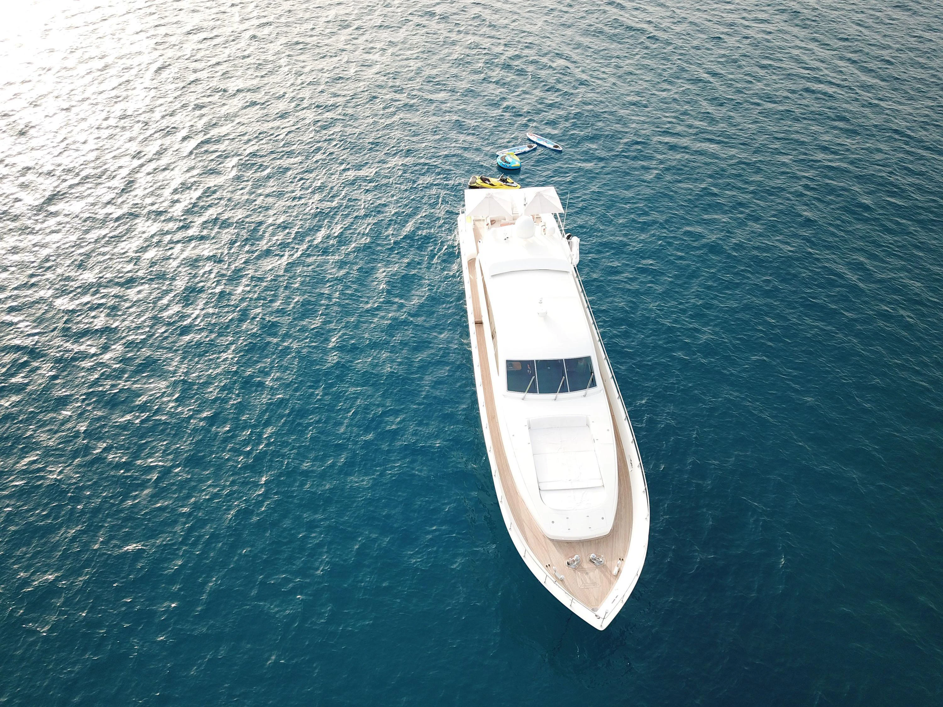 a small white boat in the water aboard VELOCE Yacht for Sale