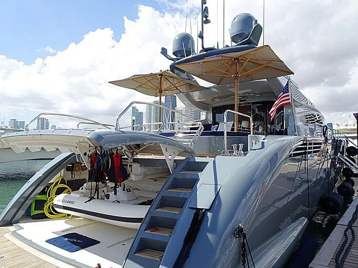 a boat with a flag on the deck aboard VELOCE Yacht for Sale