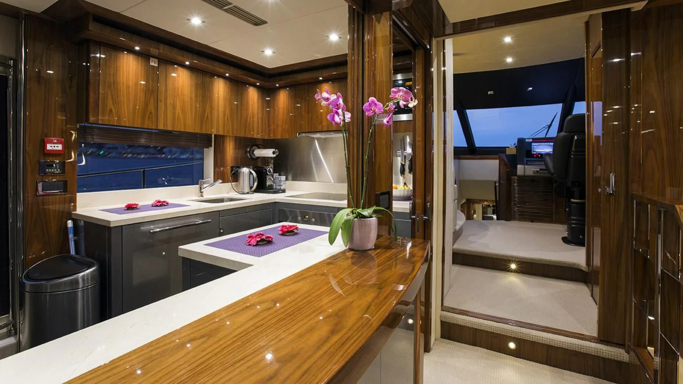 a kitchen with a counter and a plant in the middle aboard GELATO Yacht for Sale