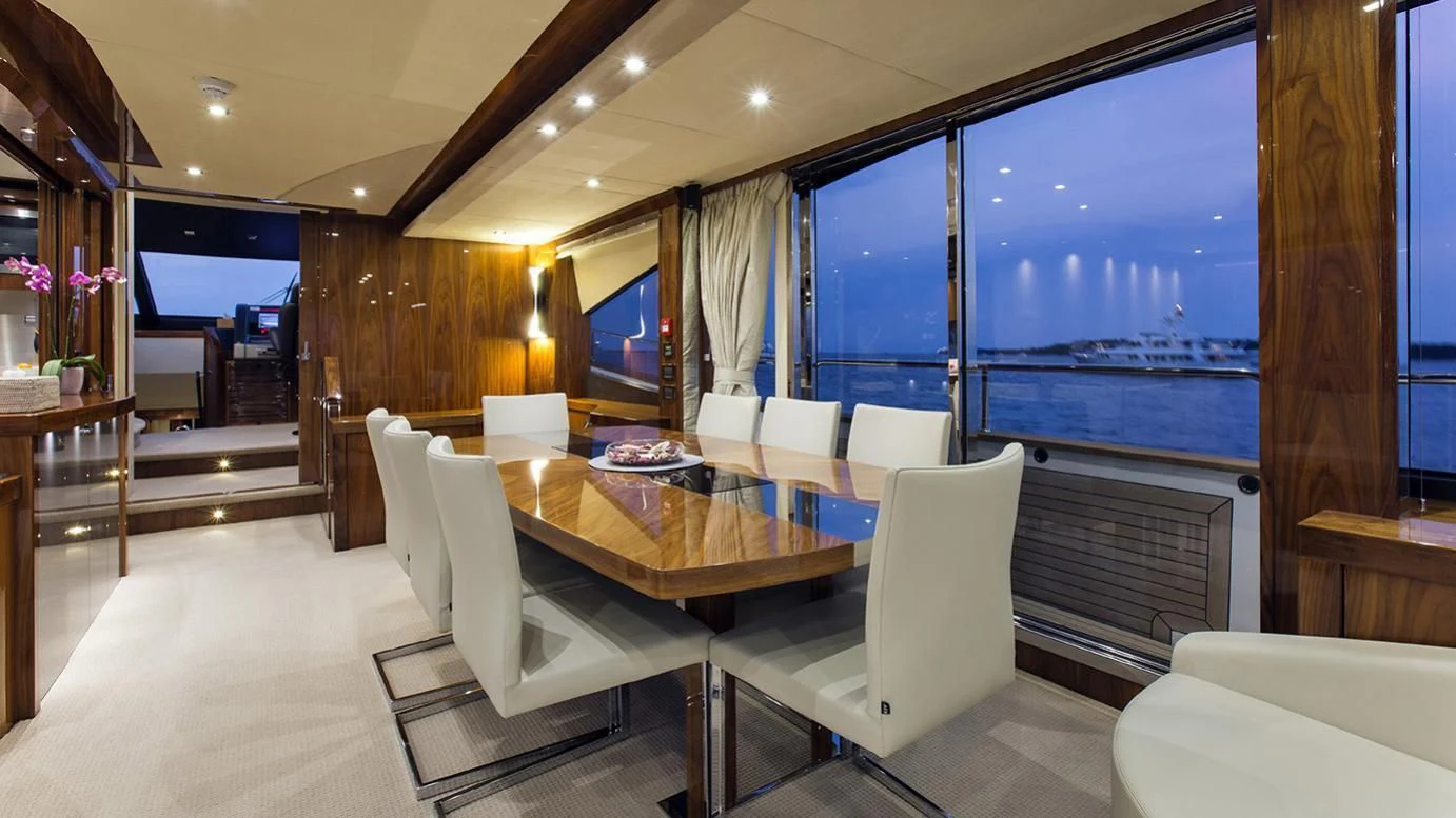 a room with a table chairs and a large window aboard GELATO Yacht for Sale