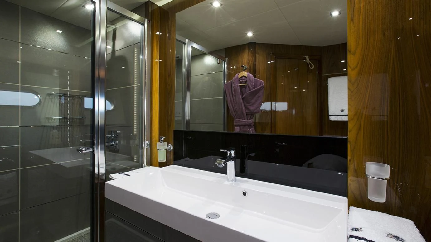 a person taking a picture of a bathroom aboard GELATO Yacht for Sale