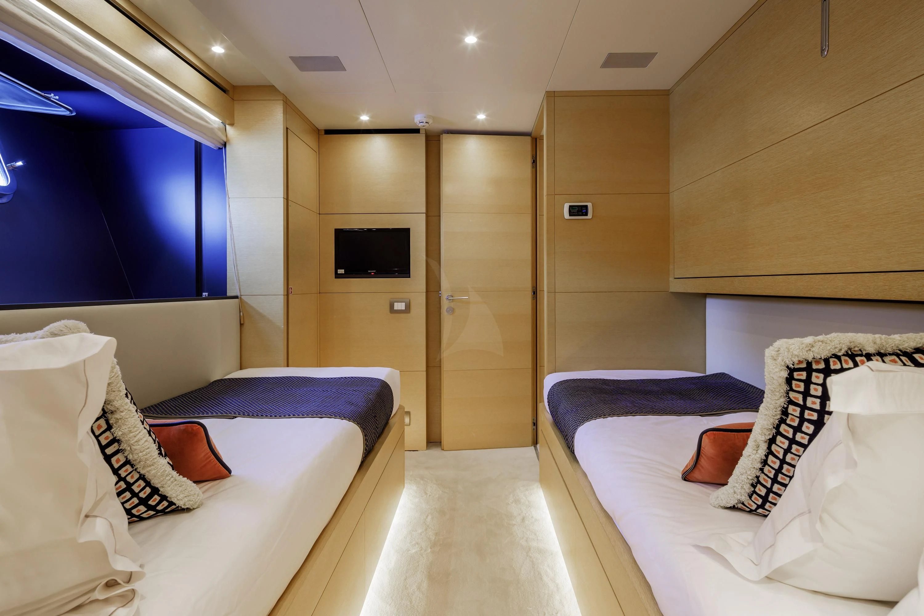 a room with beds and a tv aboard ELYSIUM Yacht for Sale