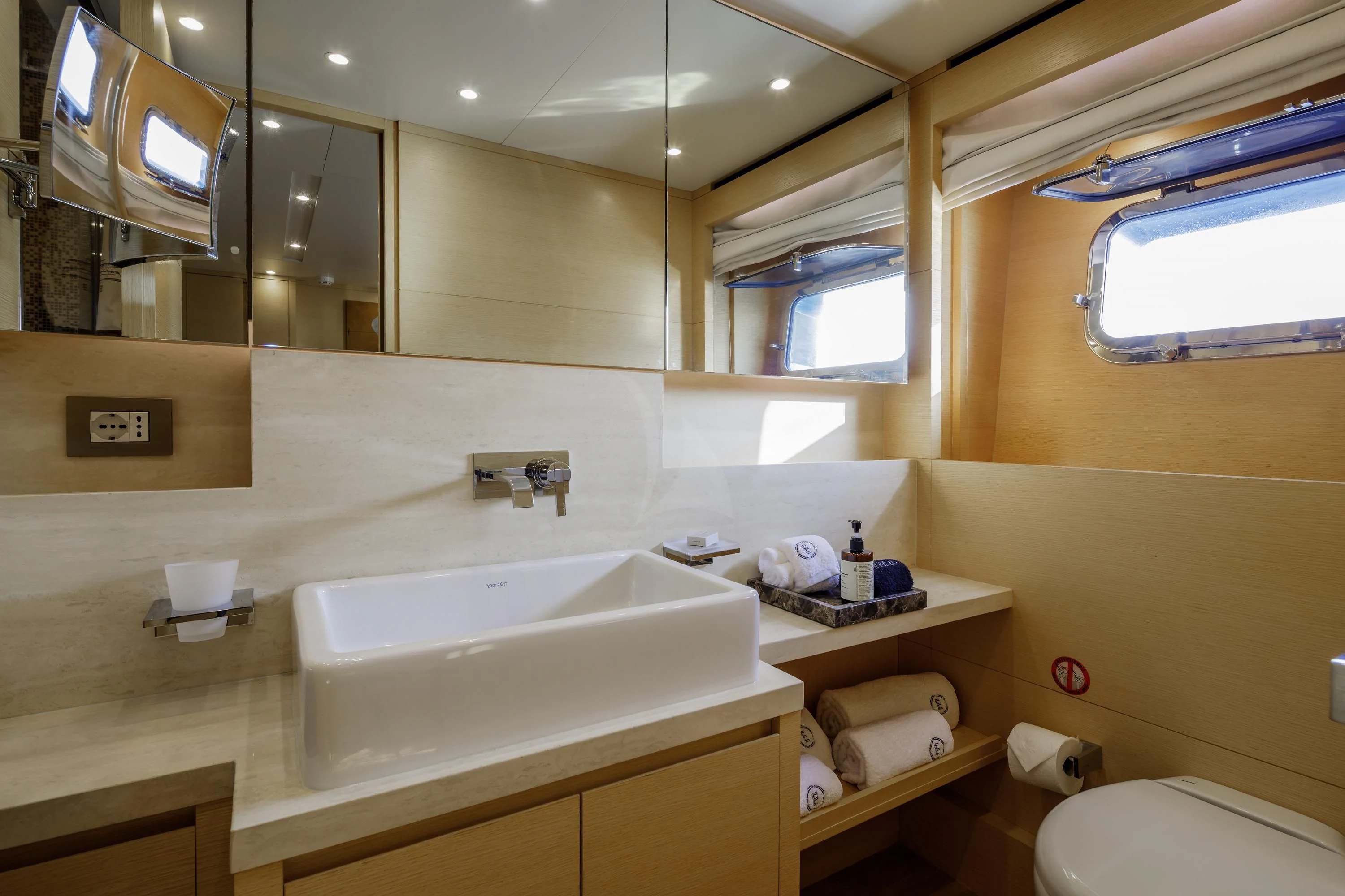 a bathroom with a sink and mirror aboard ELYSIUM Yacht for Sale