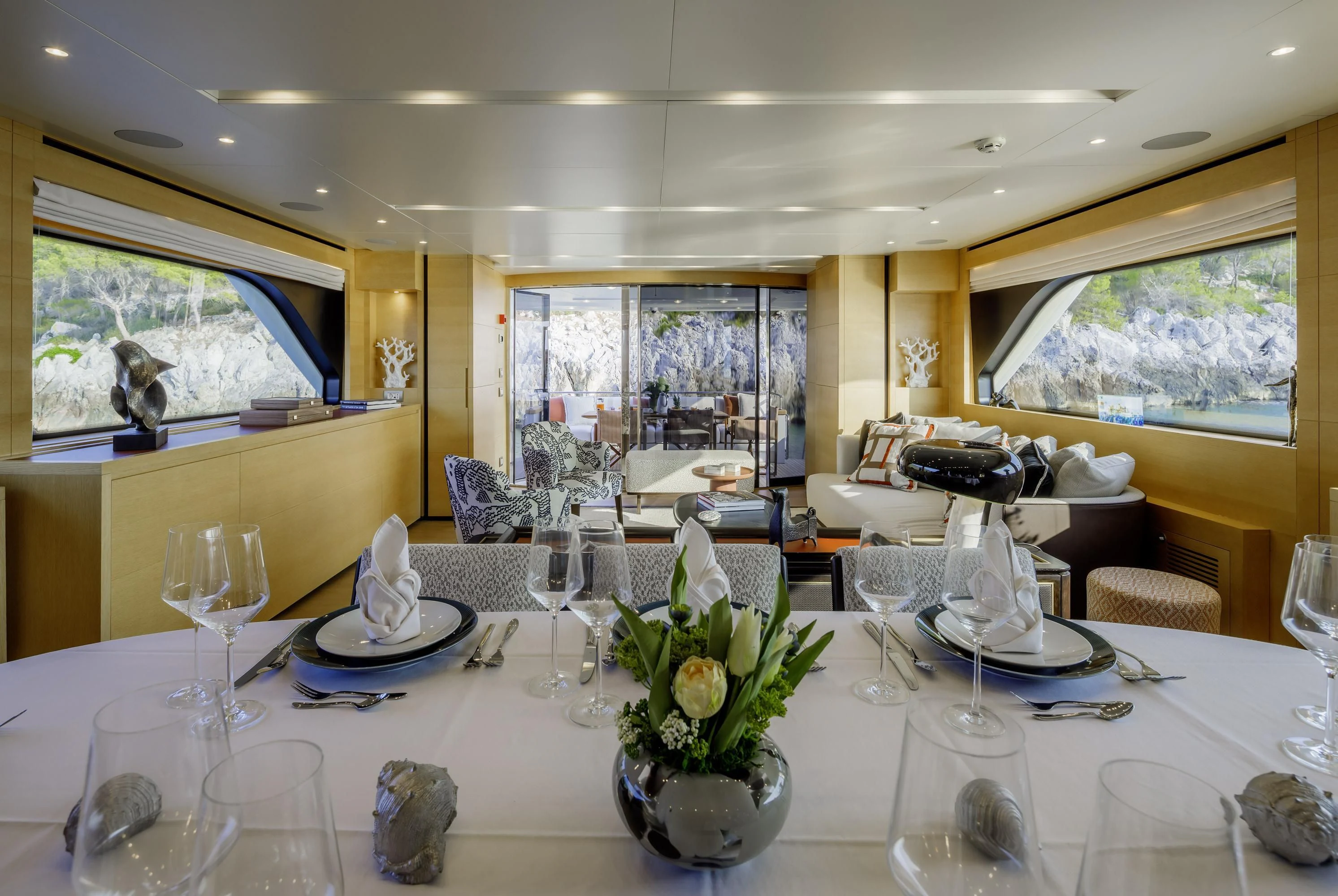 a table with wine glasses and flowers aboard ELYSIUM Yacht for Sale